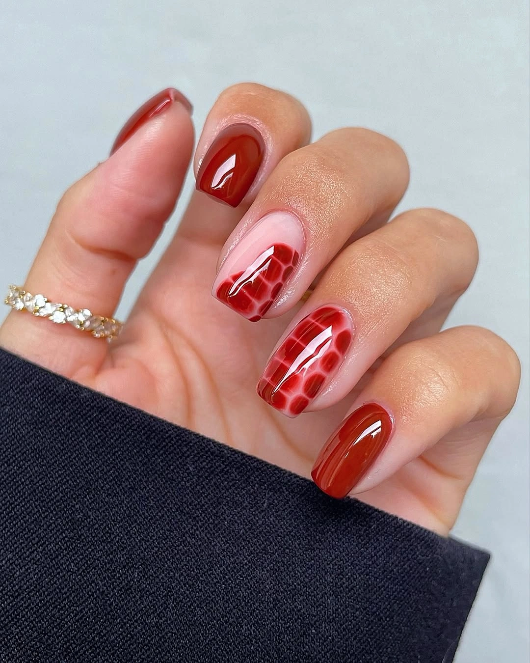 Glossy red nails with stained glass grid accent panels