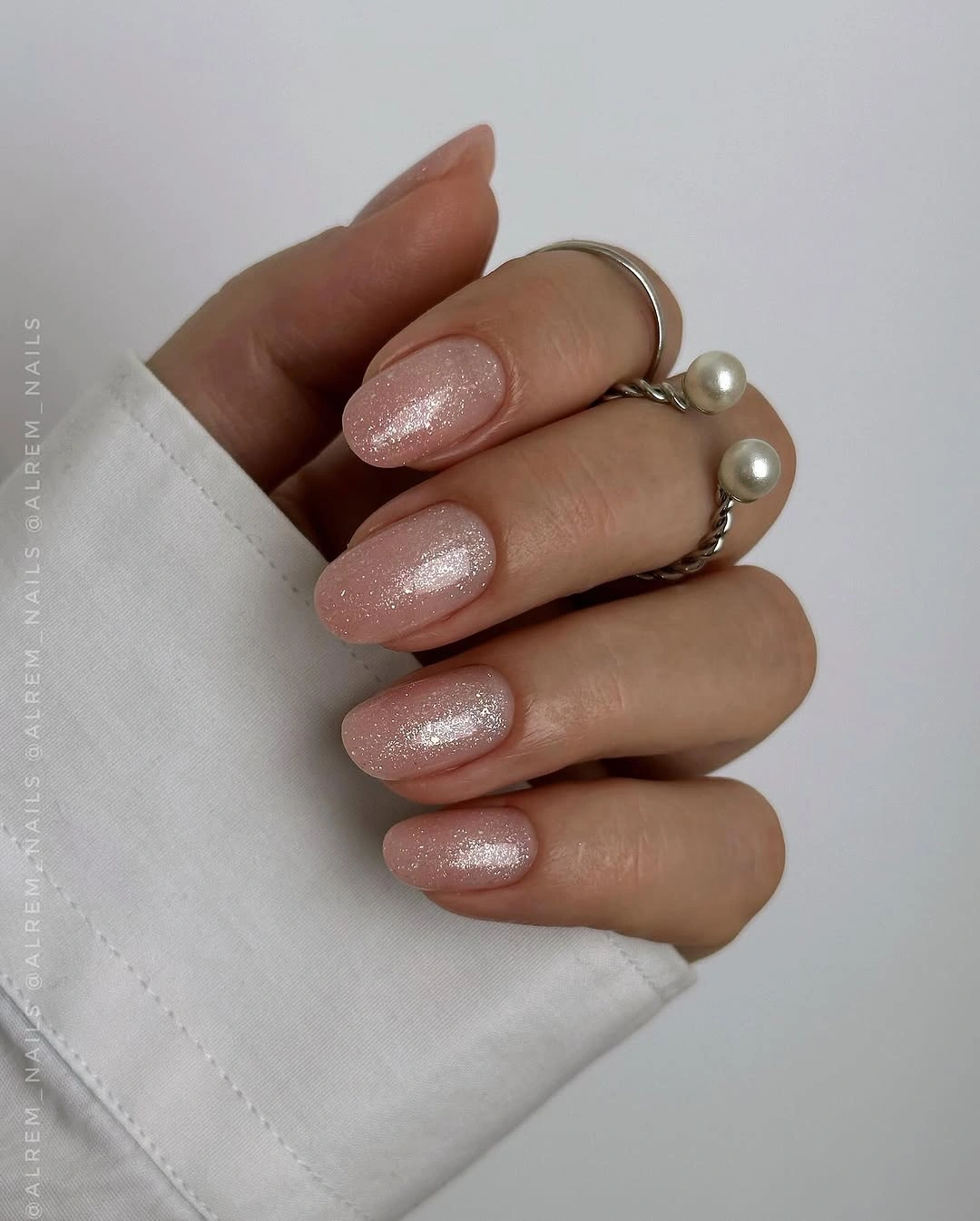 Short nude pink rounded square nails with a soft pearly shimmer