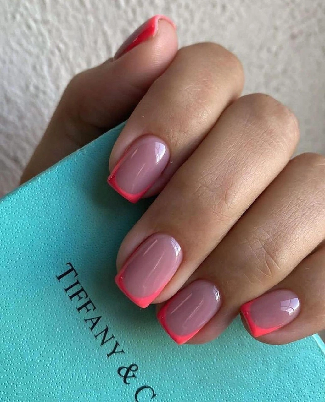 Short glossy pink squoval nails with vivid coral tips