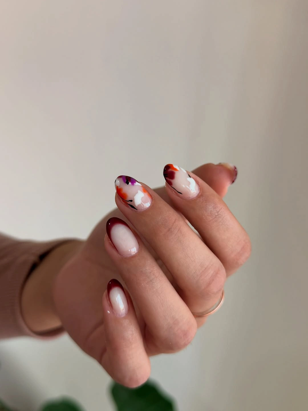 Short pale nails with burgundy outline tips and small florals