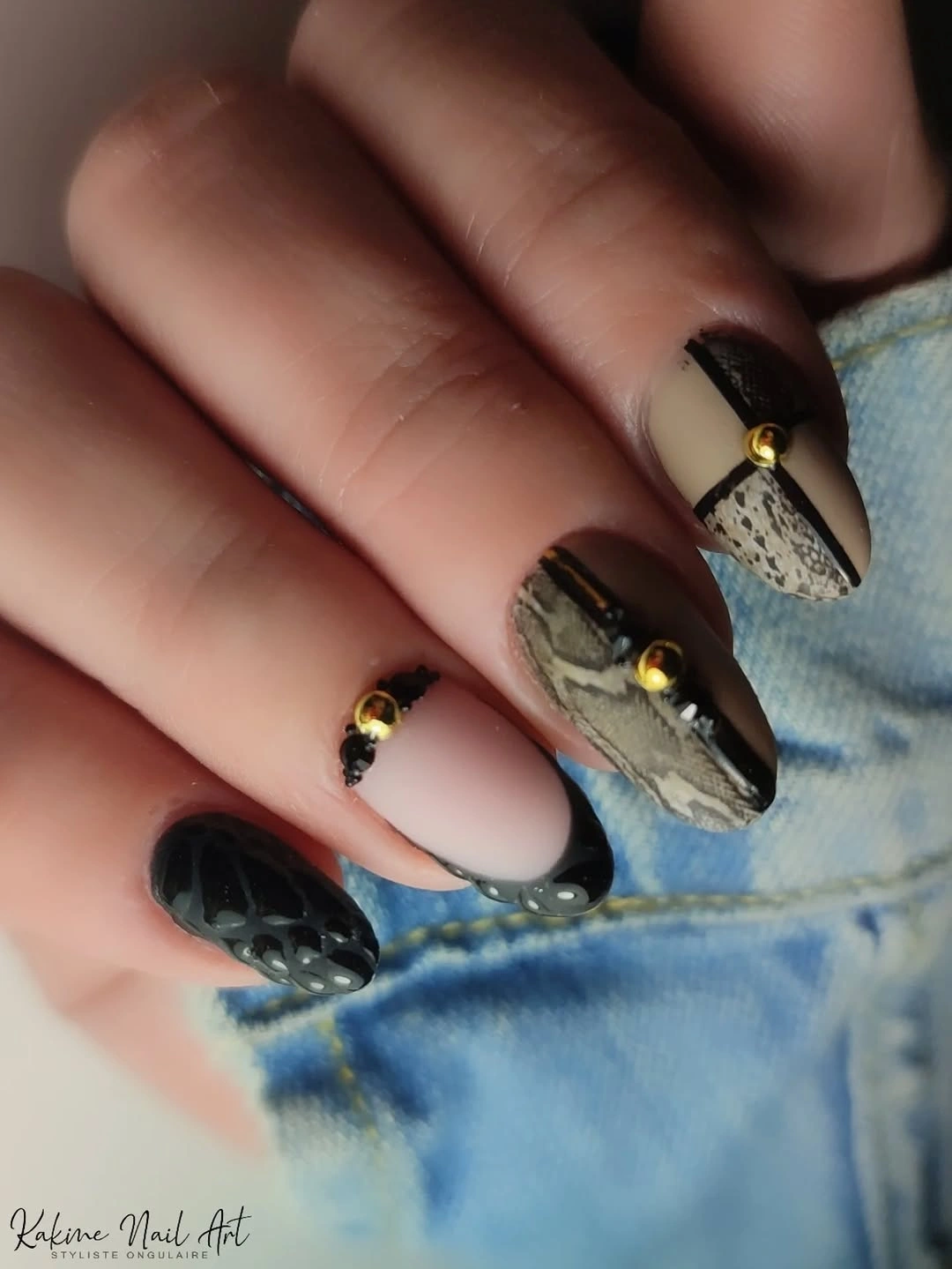 Long almond nails with black French tips tortoiseshell panels and gold
