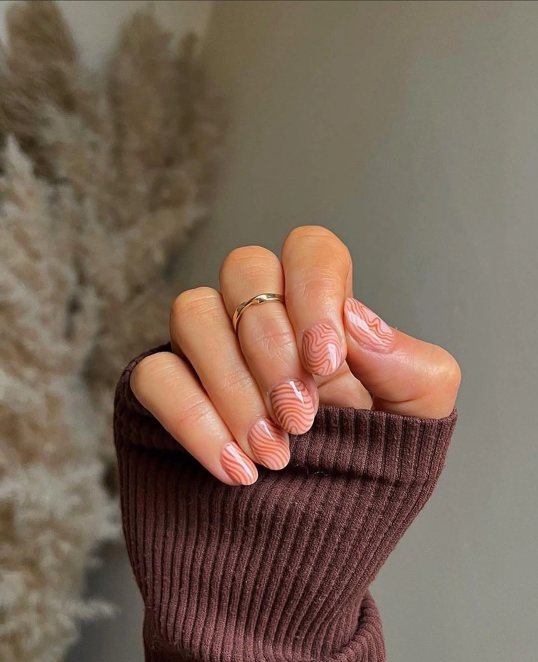 Peach pink almond nails with fine white contour waves