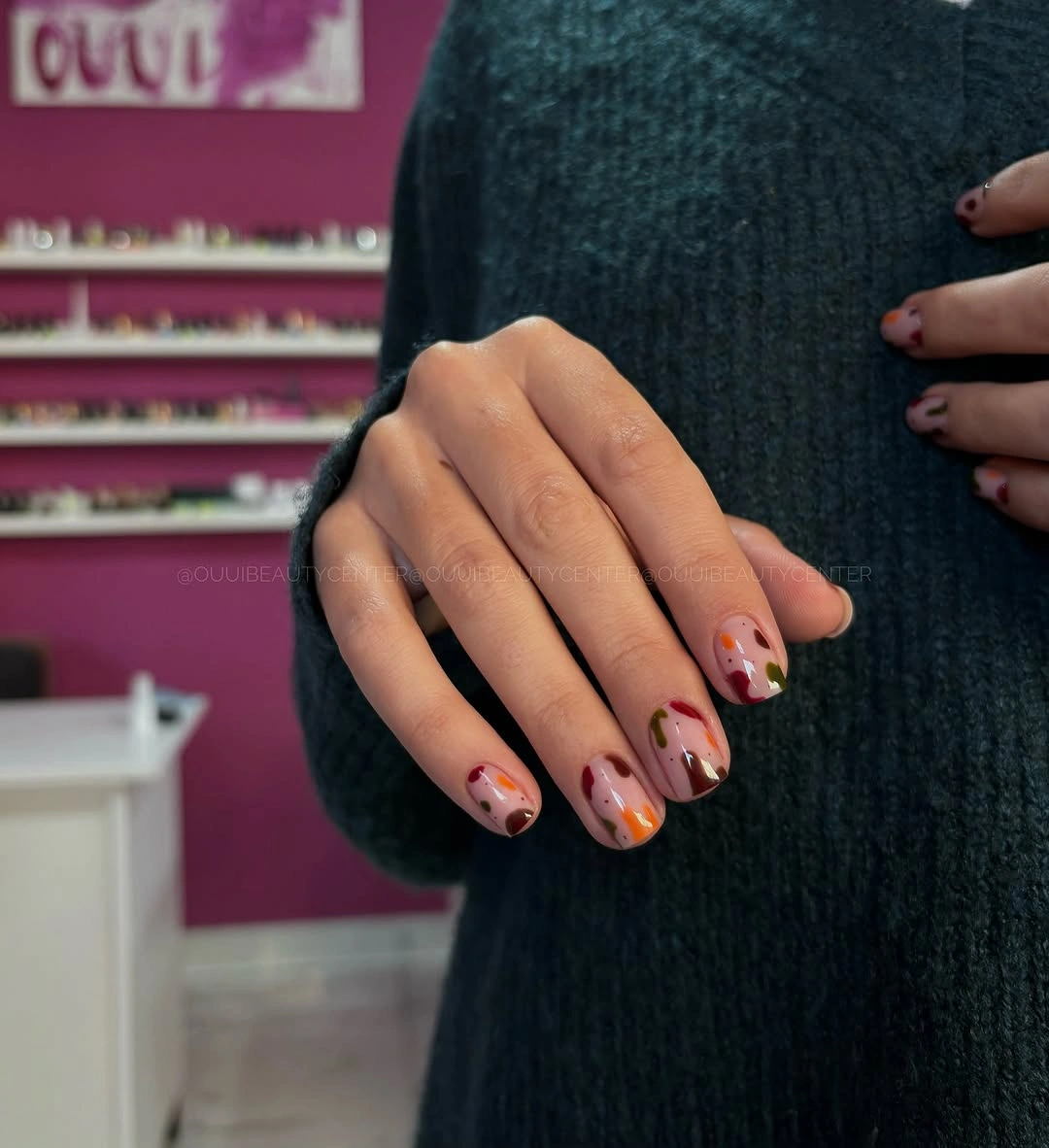 Short nude pink nails with tiny dark red tip motifs