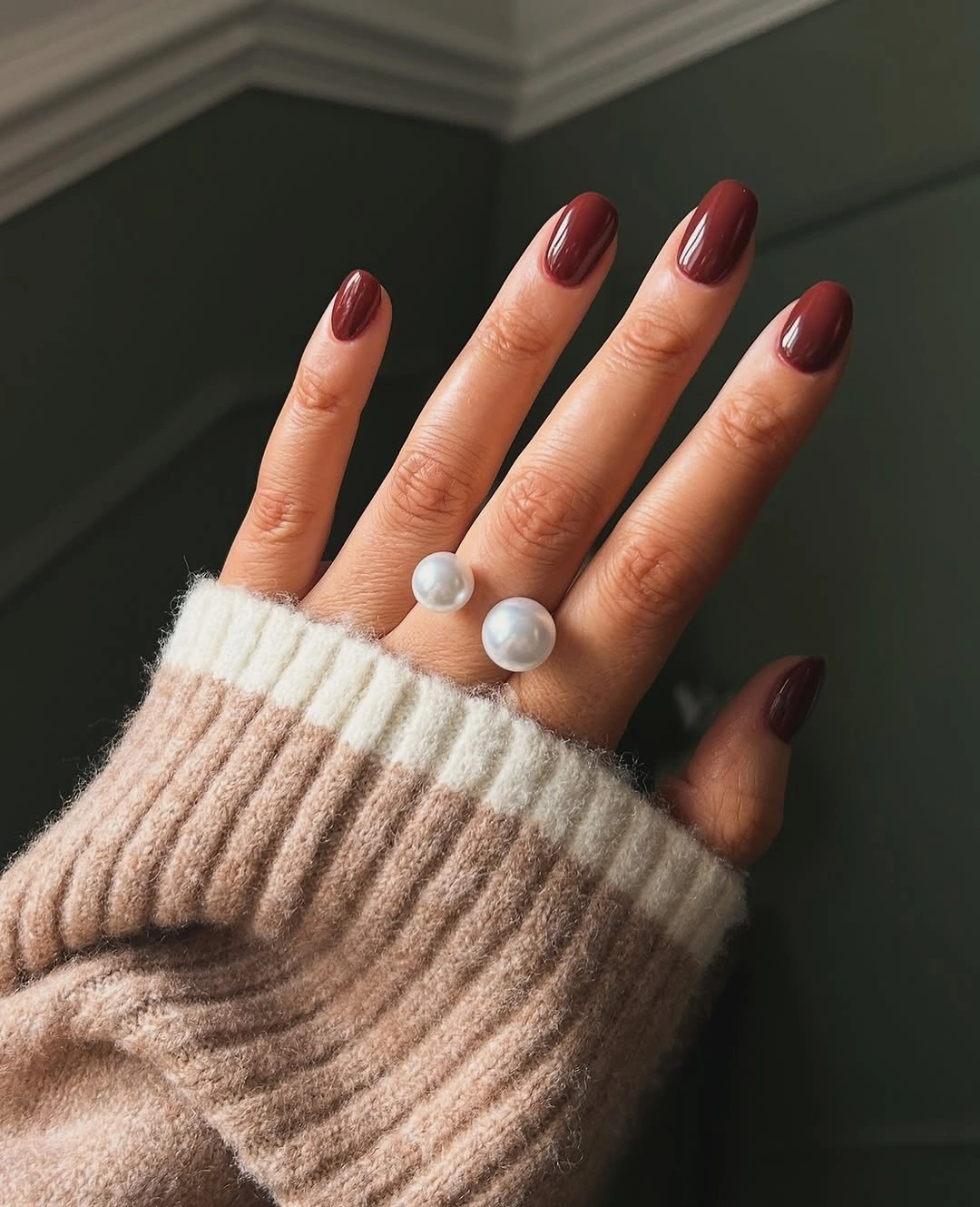 Medium almond nails in warm glossy brick red