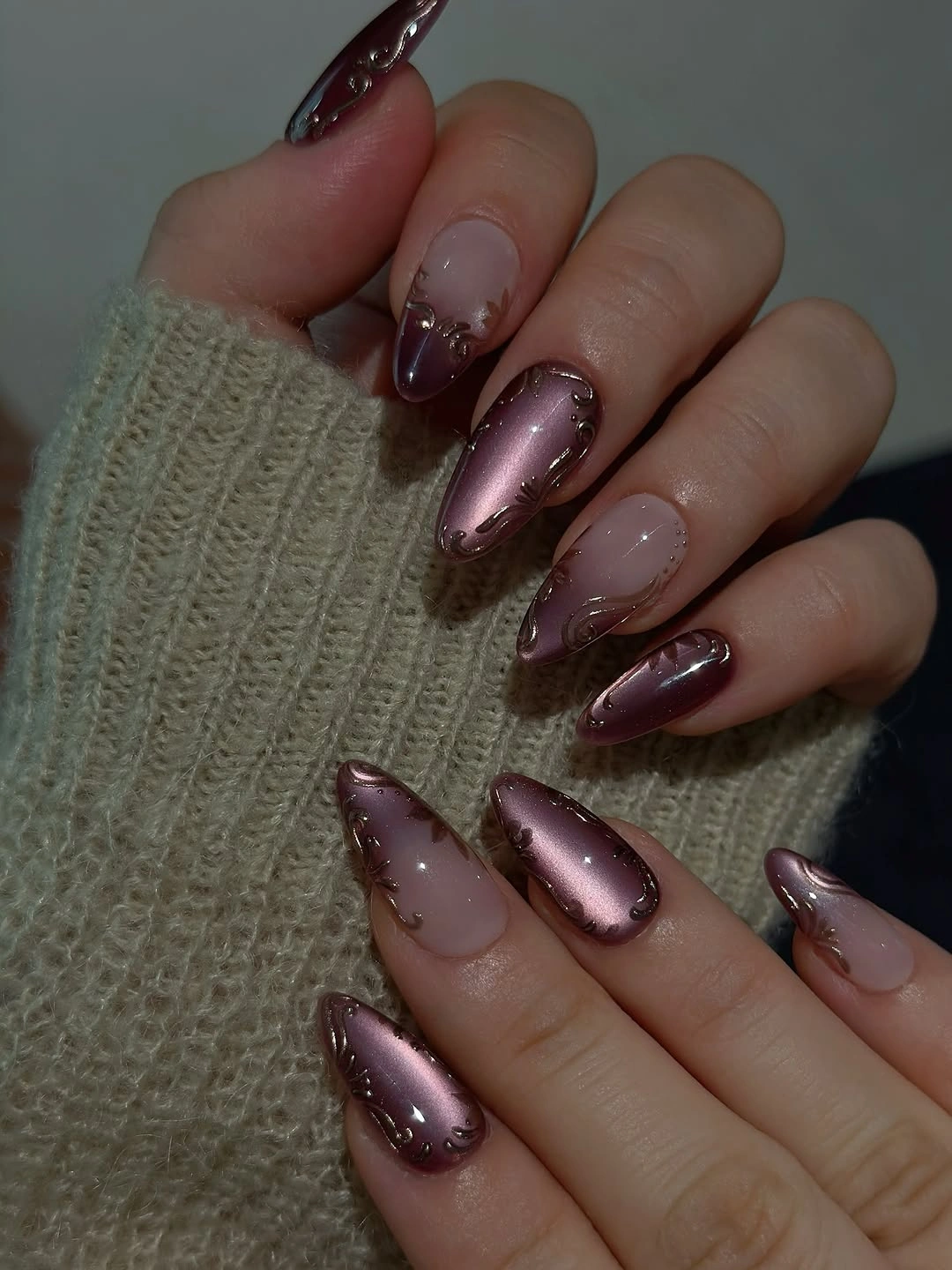 Long nude almond nails with reflective plum swirl tips