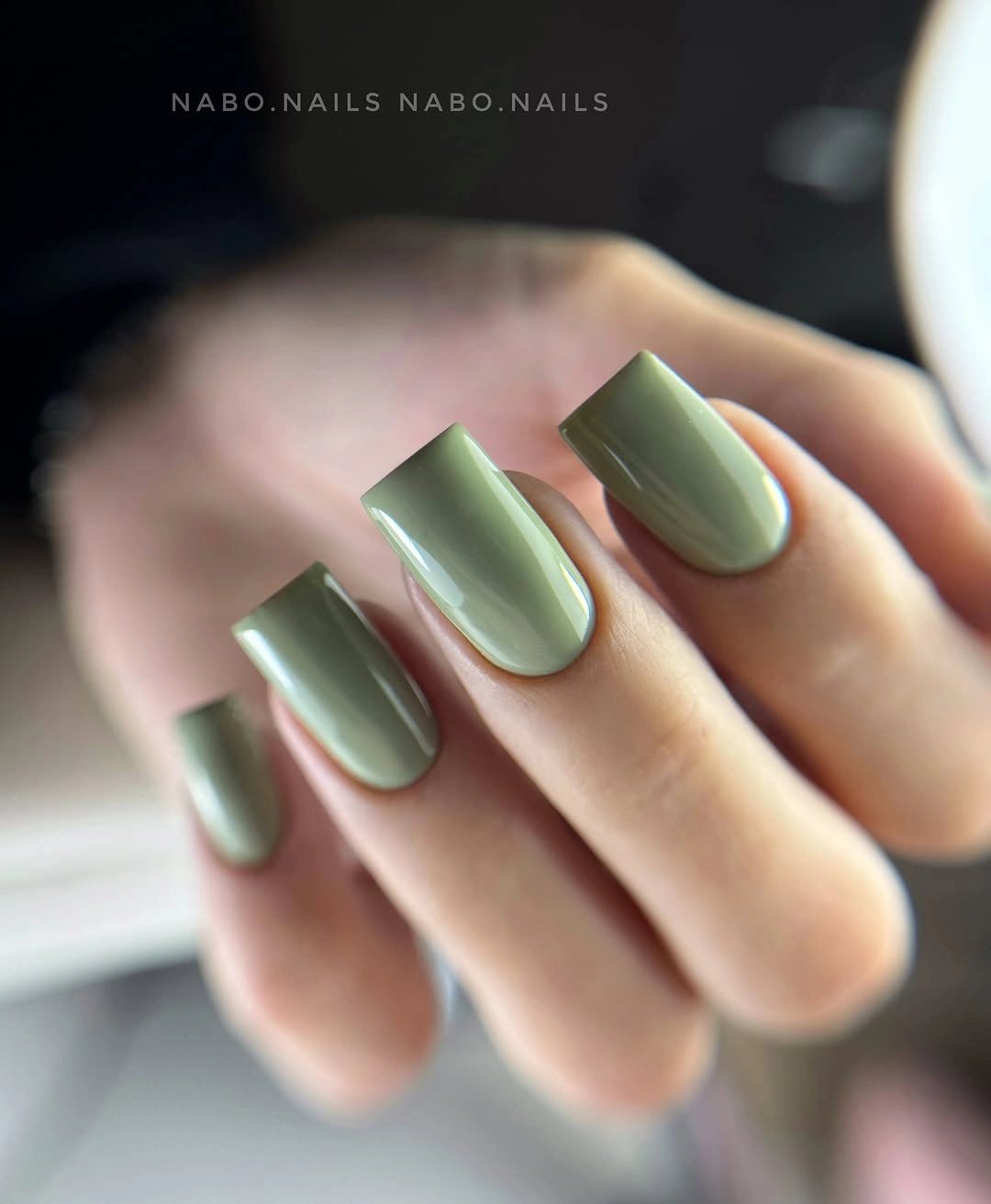 Medium square nails in soft muted glossy sage green