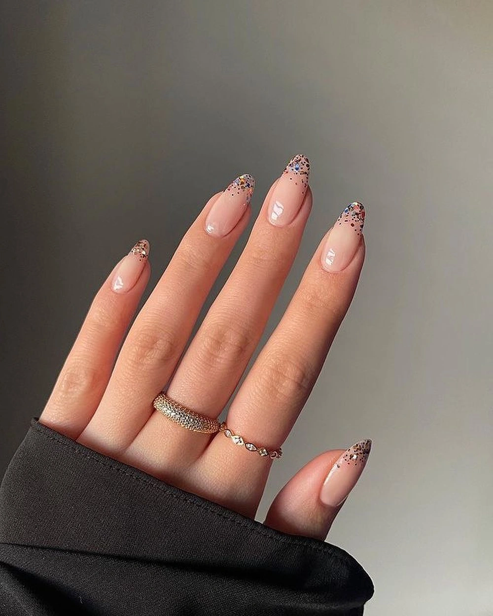 Sheer almond nails with black dotted French tips and white details