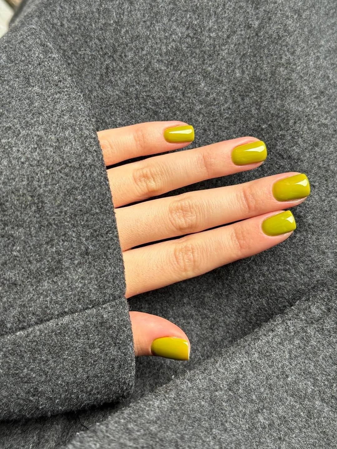 Short rounded nails in vivid glossy chartreuse yellow green