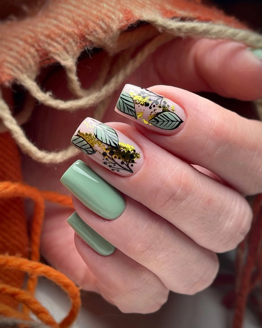 Sage square nails with leaf art black outlines and gold flecks