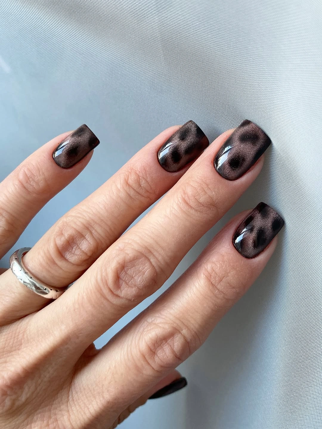 Short square charcoal nails with smoky black dotted texture