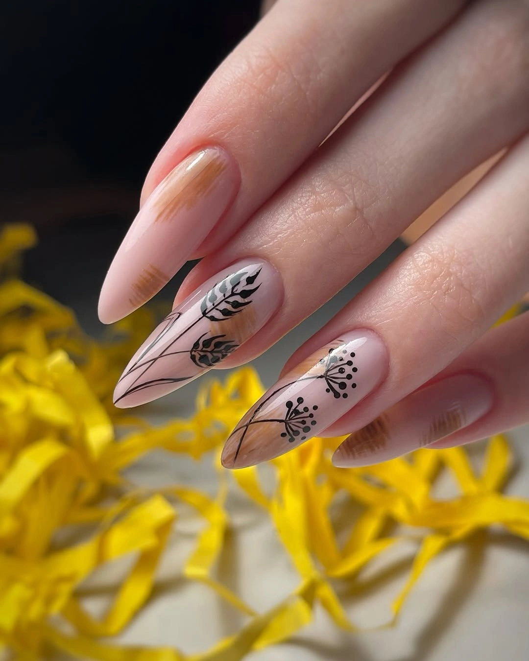 Long nude almond nails with fine black botanical line drawings