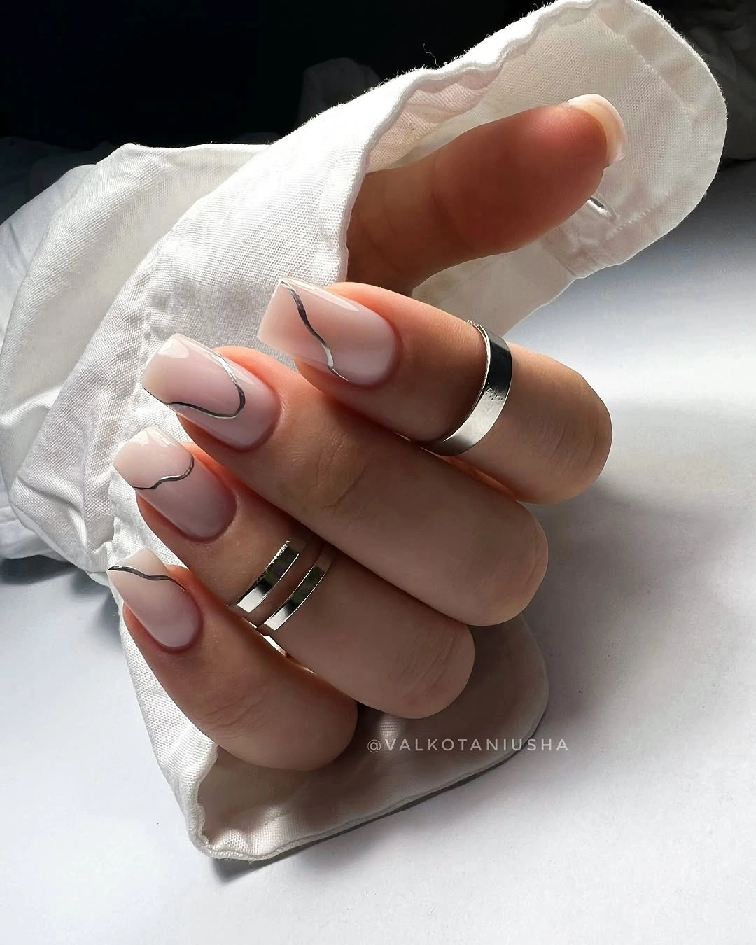 Nude almond nails with crisp white double wave French tips