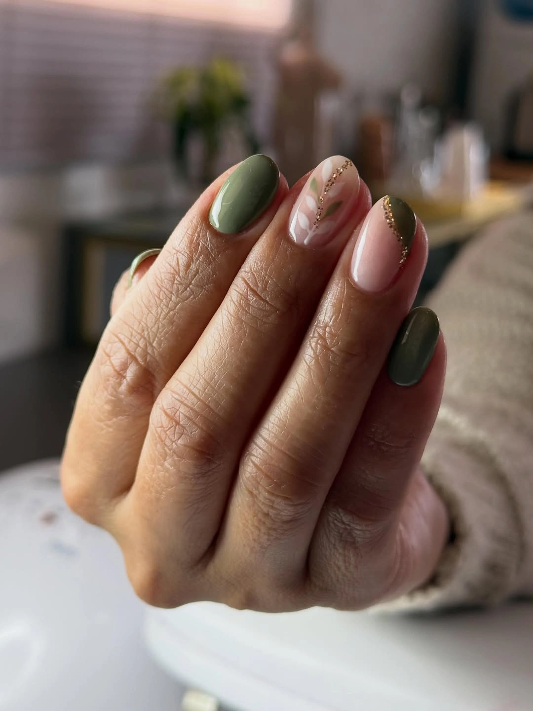 Medium sage oval nails with one delicate nude botanical accent