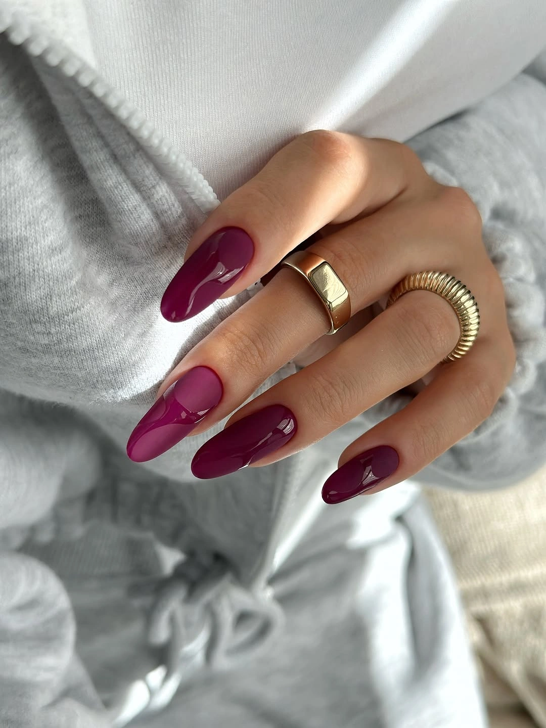 burgundy almond nails with gold accent