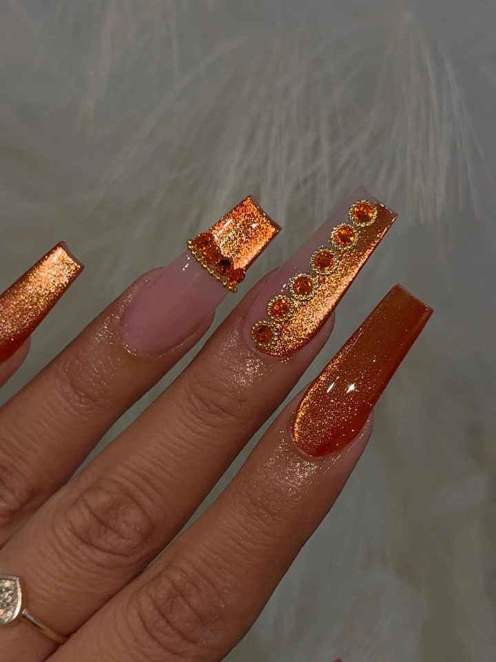 nude square nails with orange glitter panels