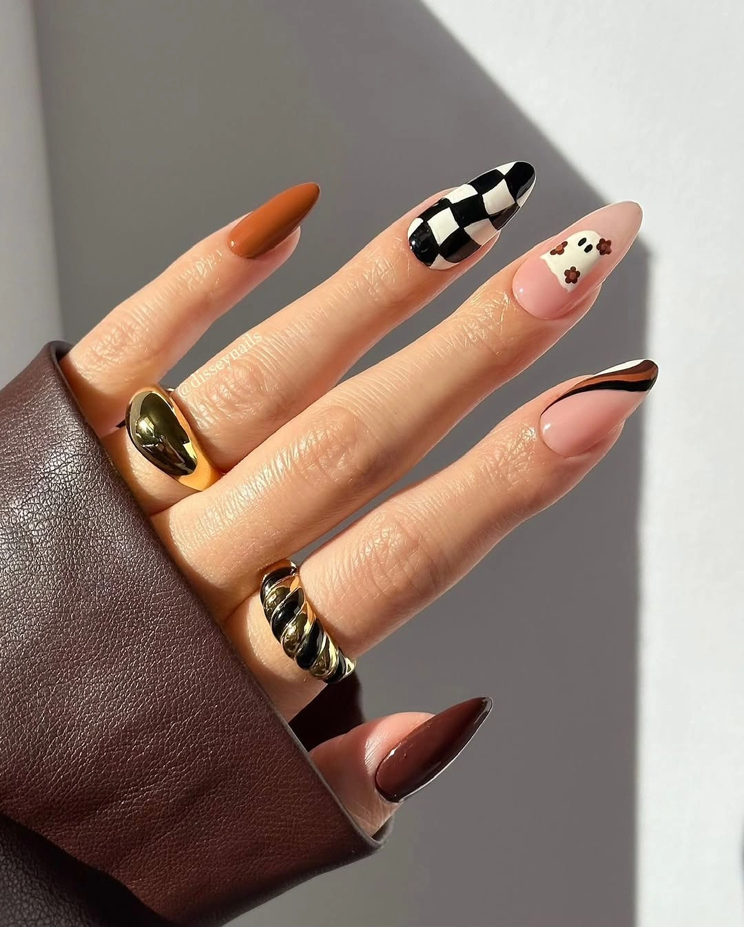 orange almond nails with checkerboard accents