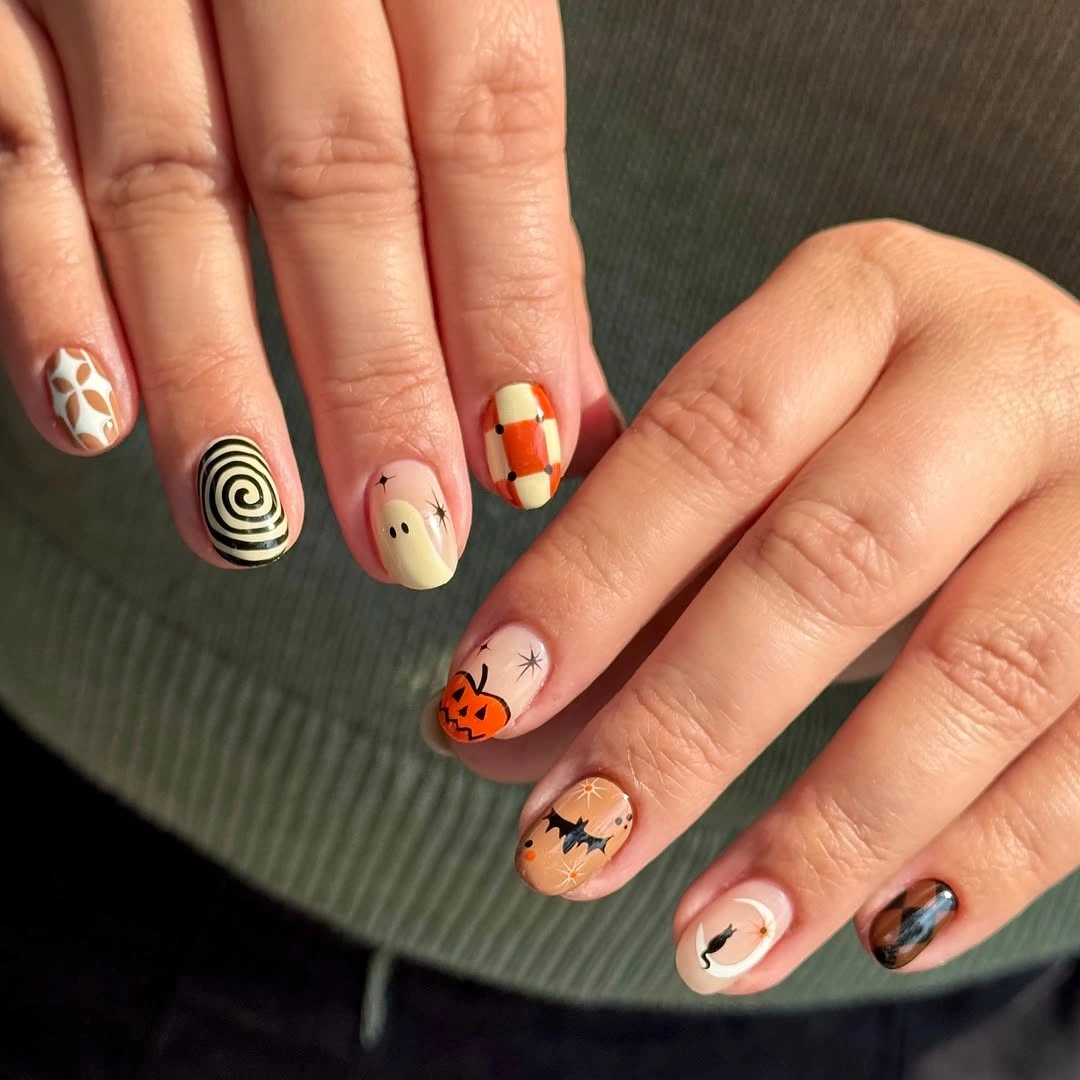 sage peach short nails with tiny pumpkins