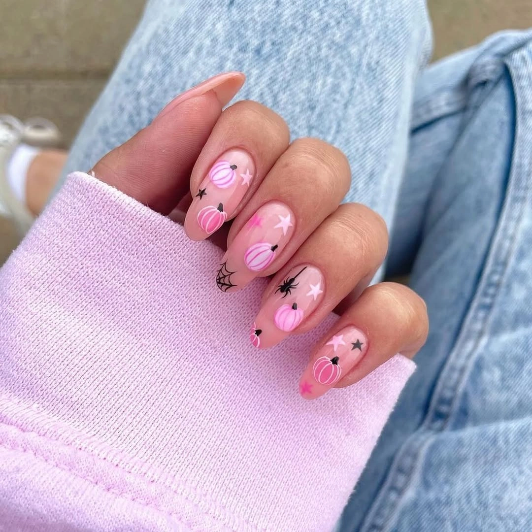 Short pink and lilac nails with airy tiny seasonal marks and stars
