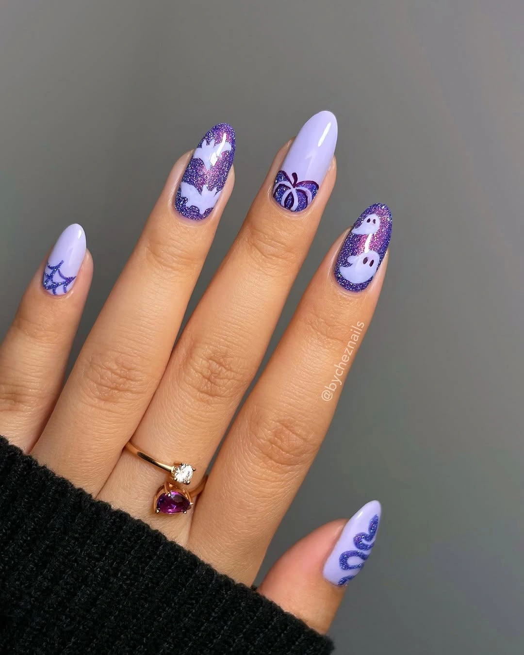 Medium almond lilac nails with violet and white Halloween motifs