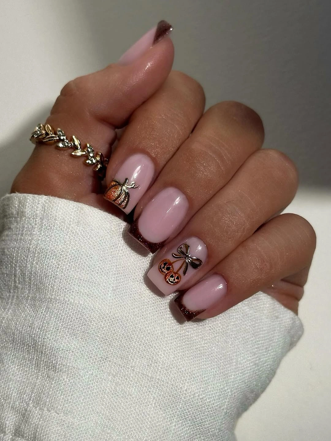 Long mauve almond nails with burgundy edges and delicate fall accents