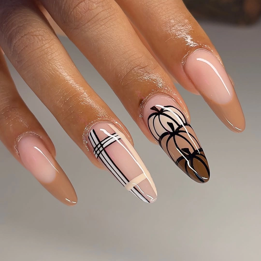 Long almond nude nails alternating plaid and orange pumpkin accents
