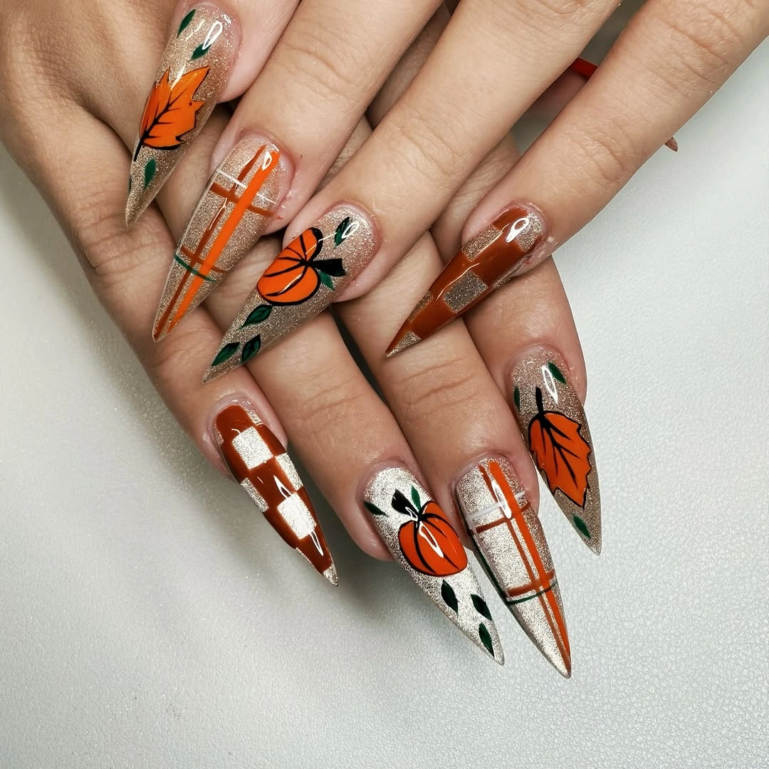 Very long stiletto nails with pumpkins plaid leaves and checkerboard details