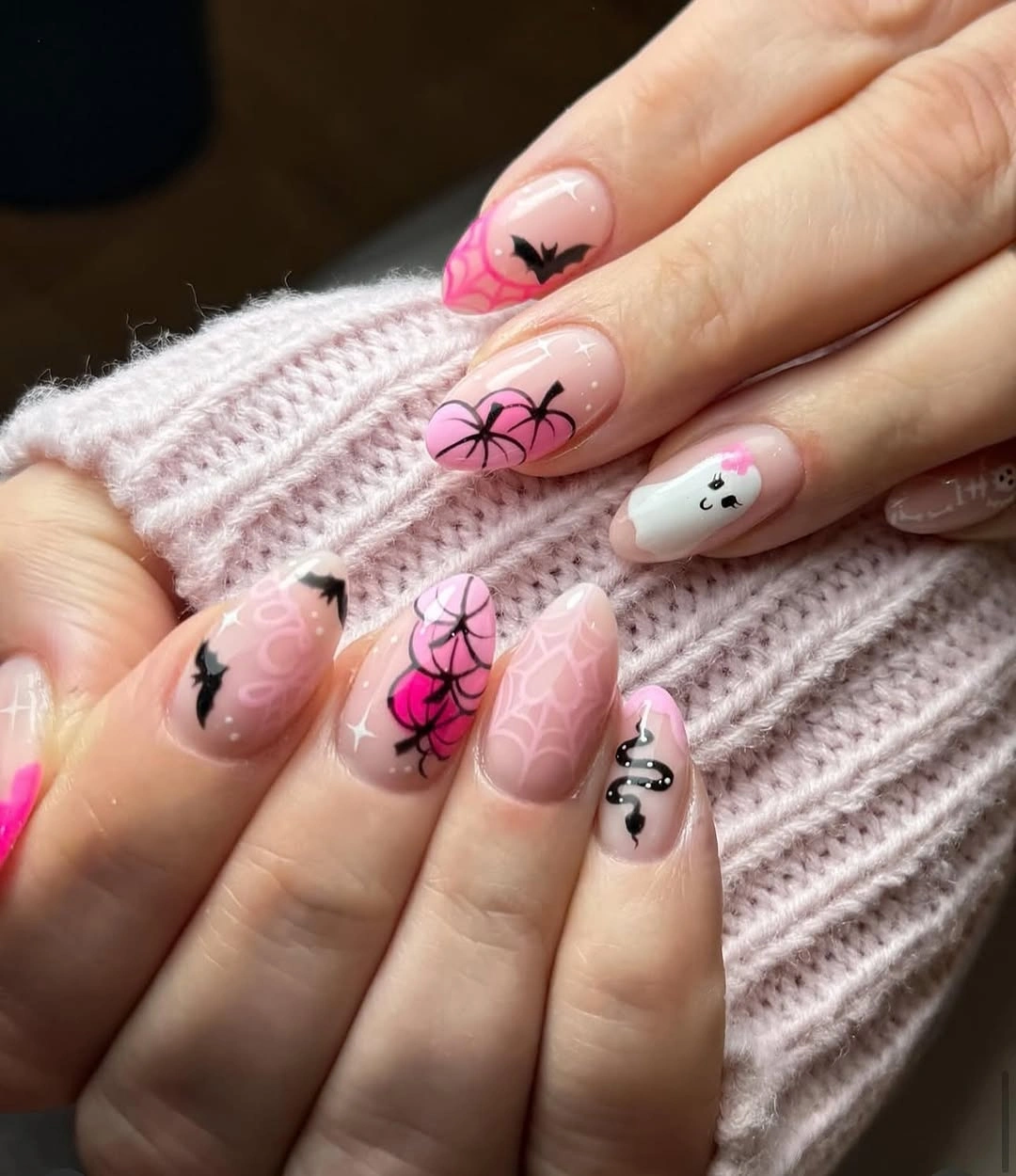 Short pink nails with black web-like lines and tiny seasonal details