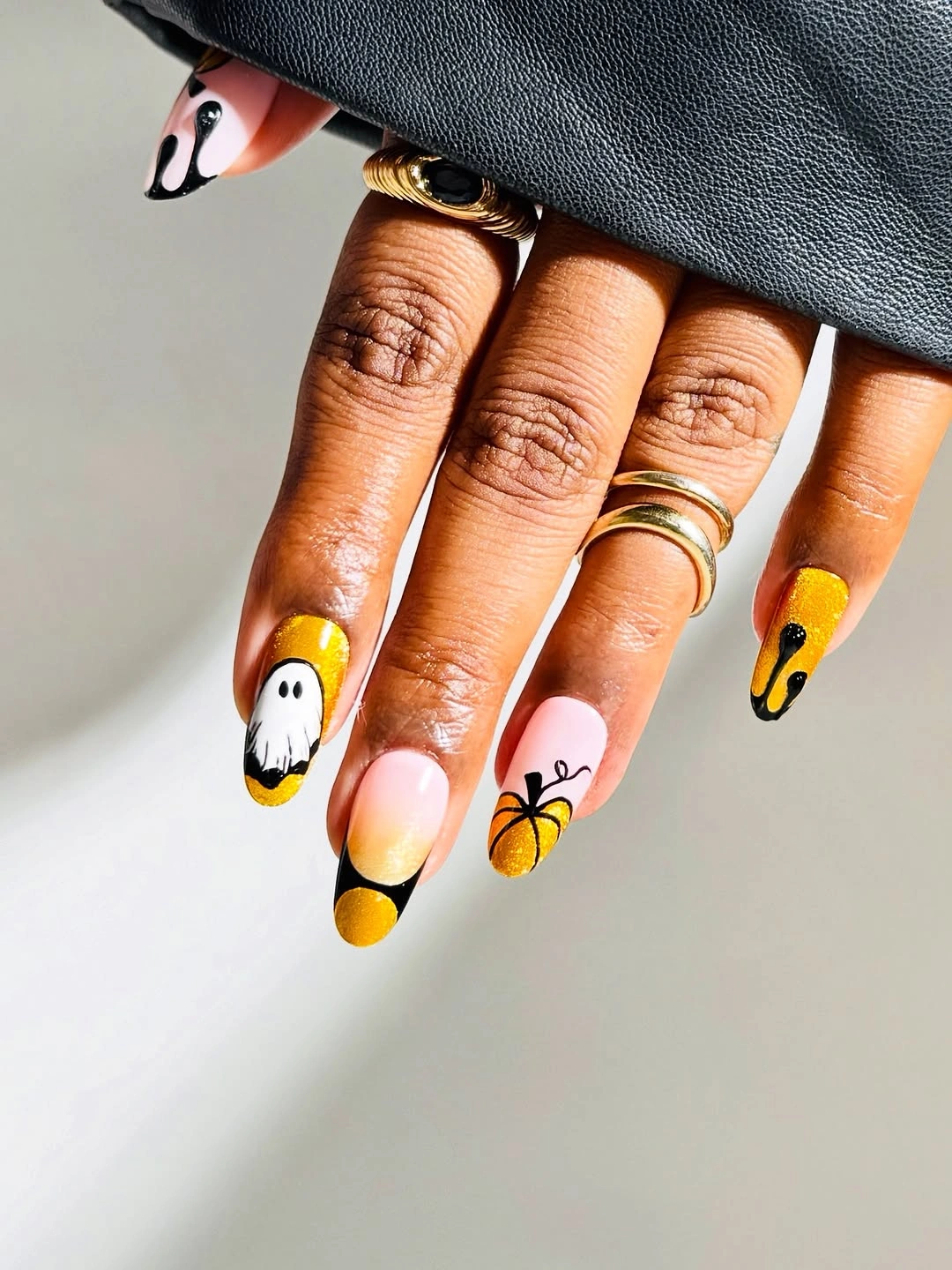 Long almond yellow and pink nails with dark tips and seasonal accents