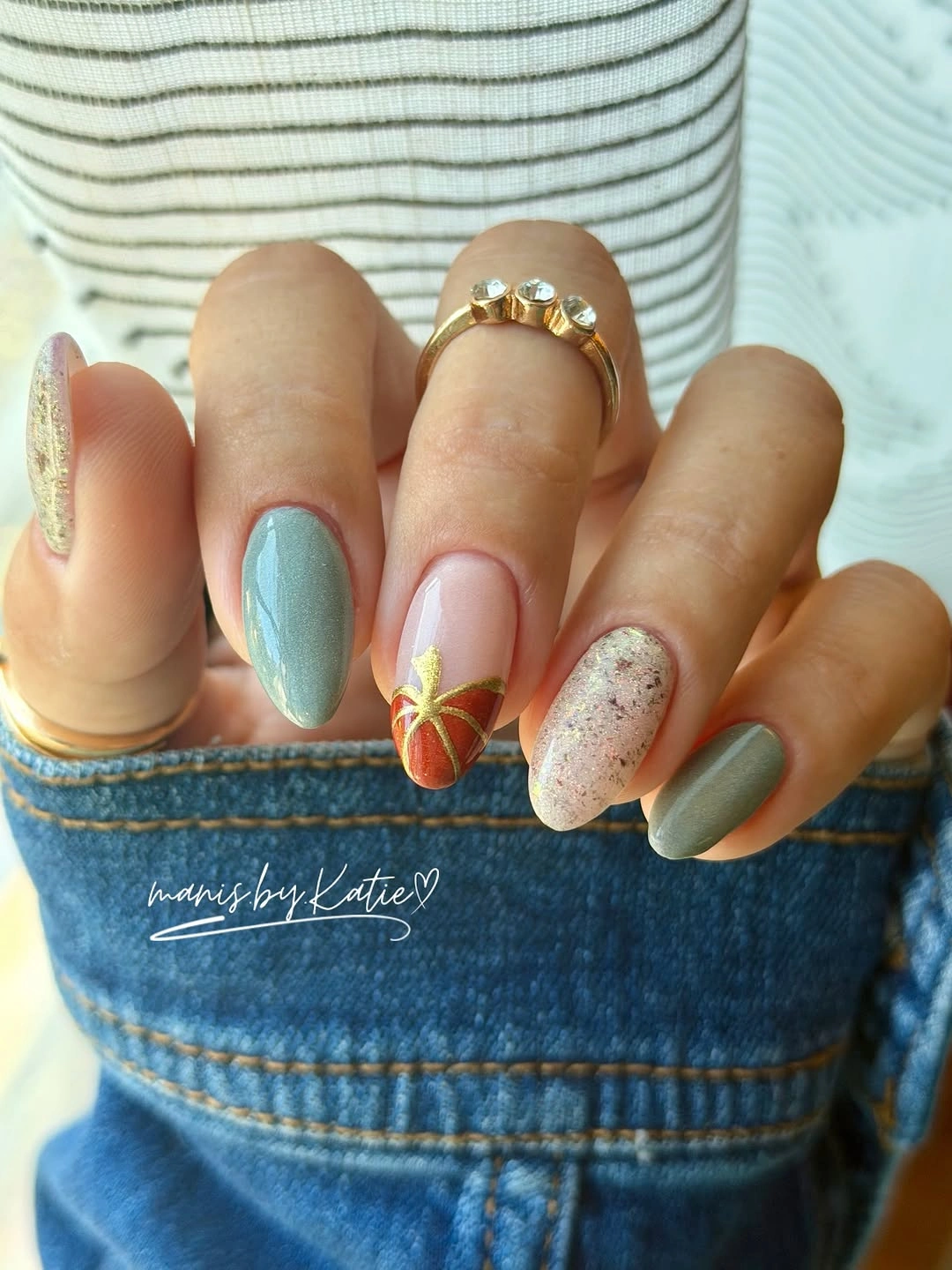 Muted blue gray nails with small warm fall accents and soft detail