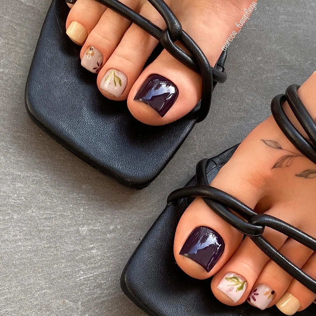 Deep purple pedicure with leafy accent toenails