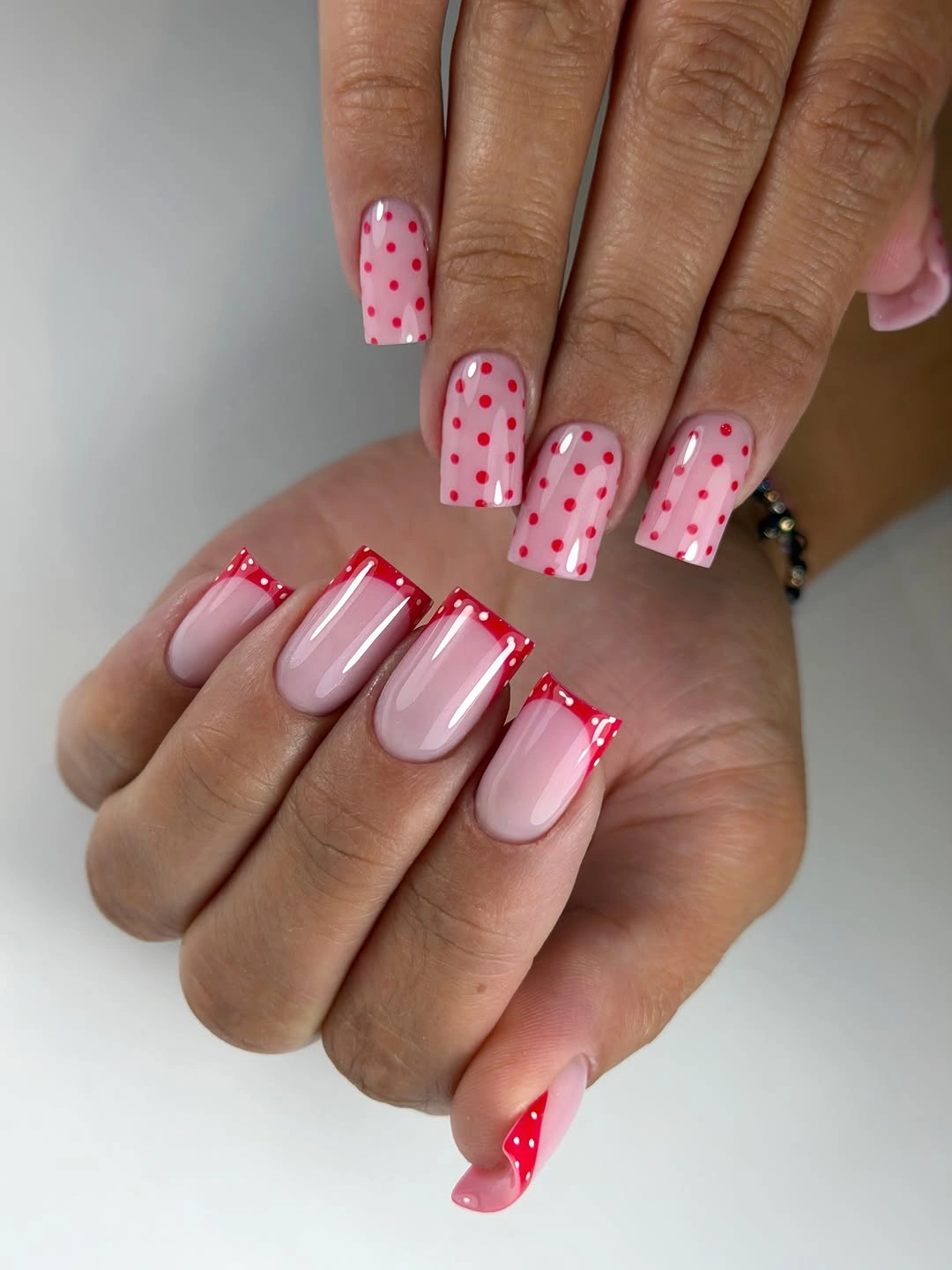 Pale square nails with red polka dots
