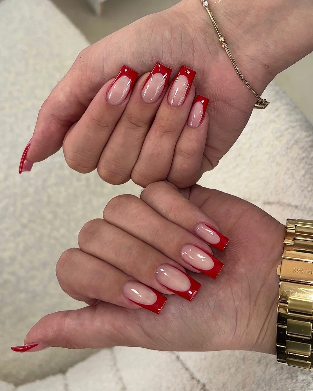 Sheer nude nails with bright red French tips