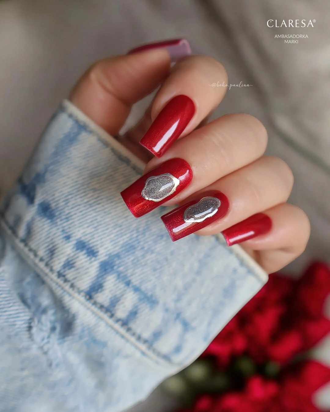 Long red square nails with silver oval accents