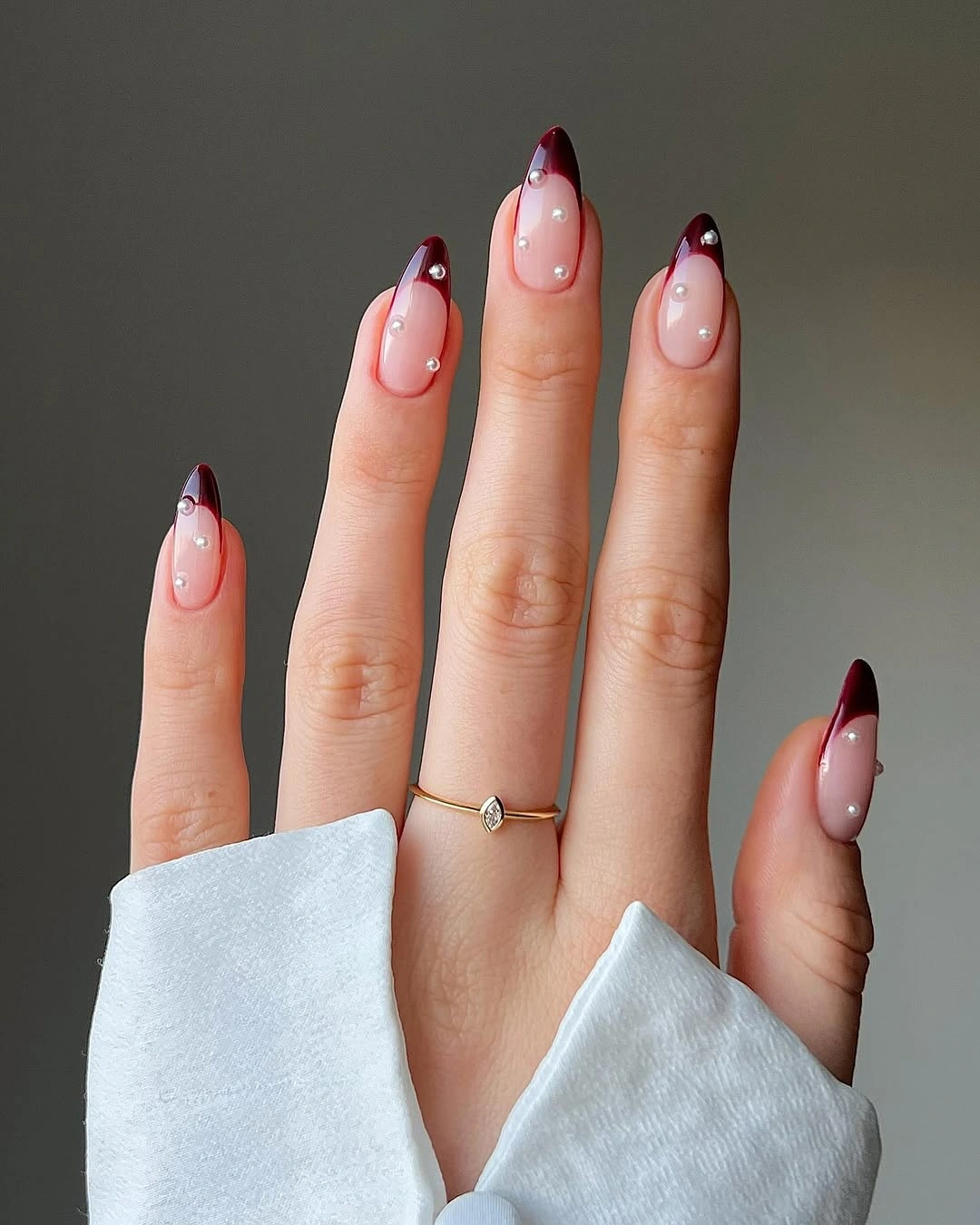 Burgundy almond tips with pearl like dots