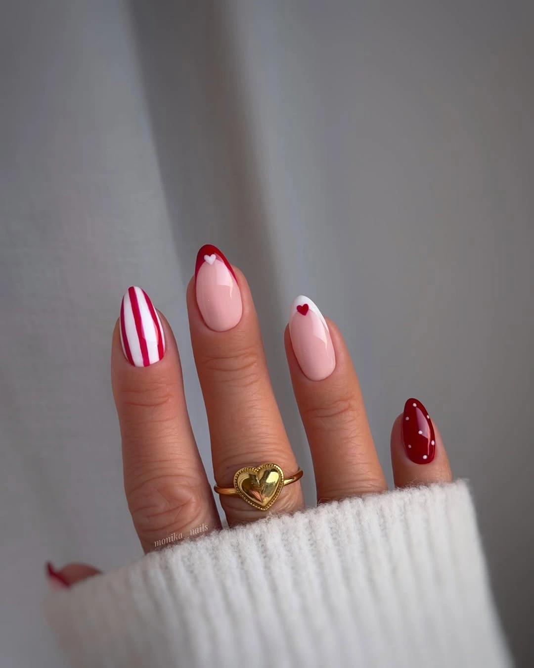 Red striped almond nails with tiny hearts