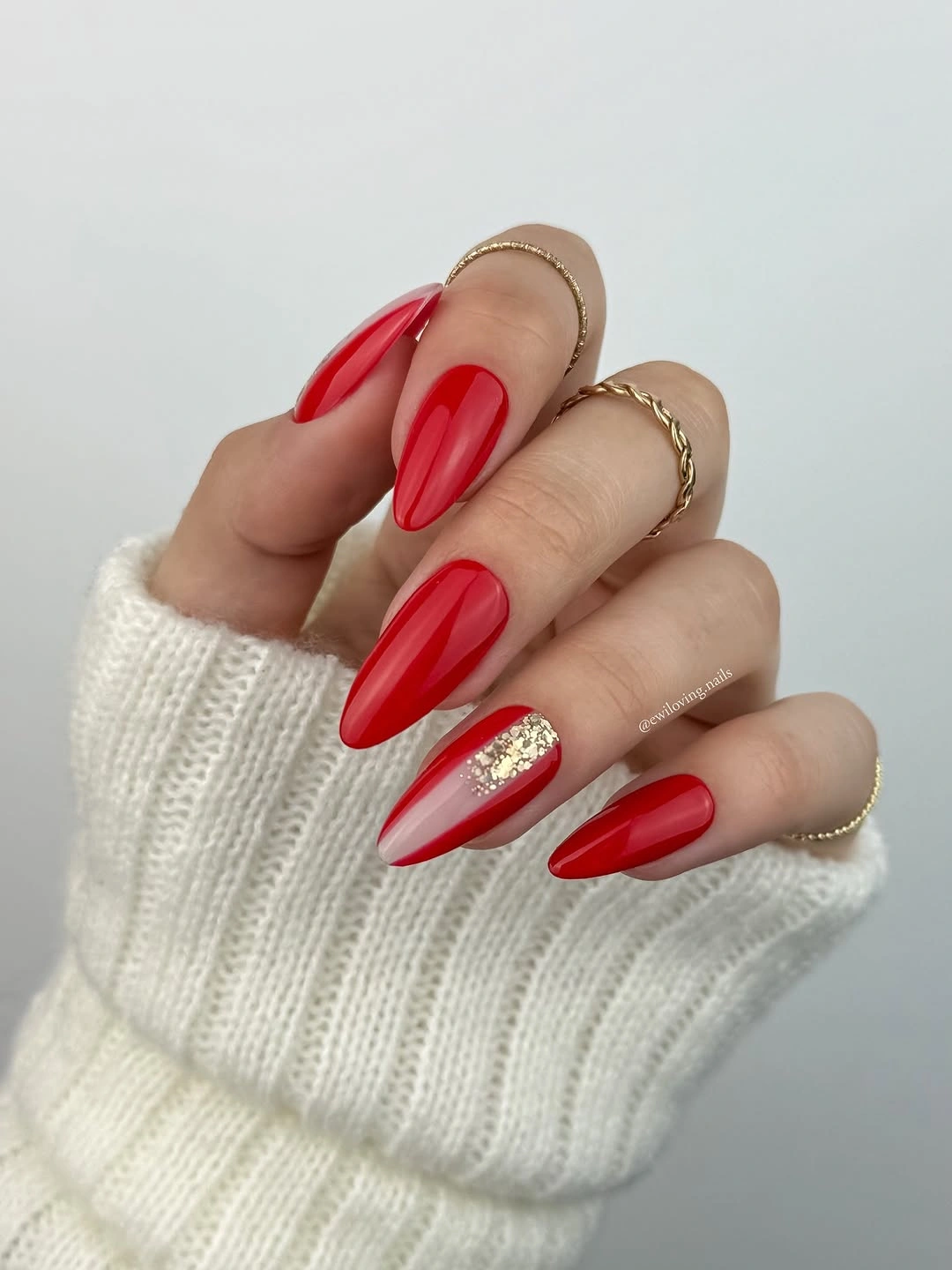 Red almond nails with gold glitter accent