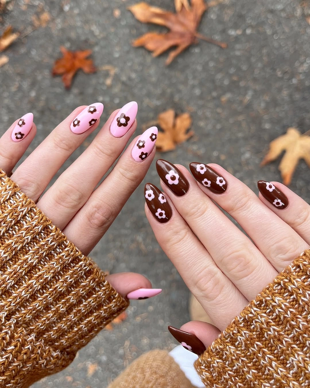 Medium almond pink and chocolate brown nails with small black and white motifs