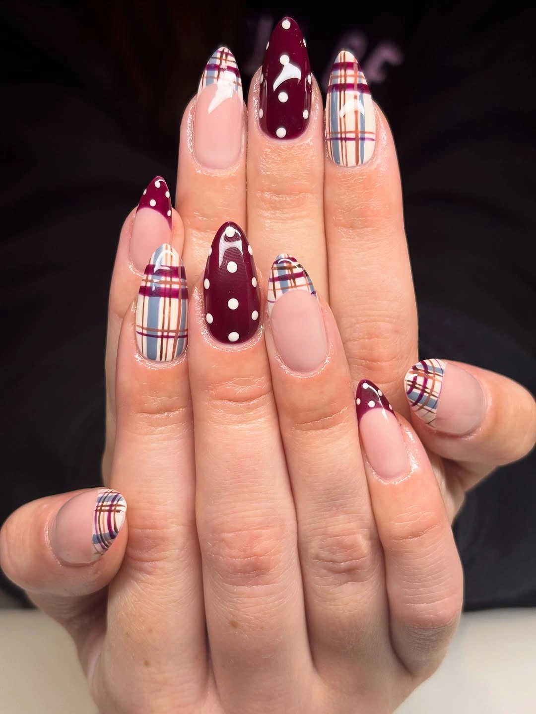 Medium-long almond nails in burgundy sheer pink and plaid lines