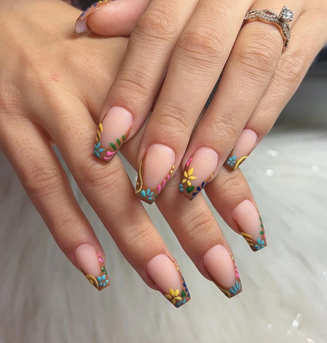 short nude coffin nails with colorful floral tip accents