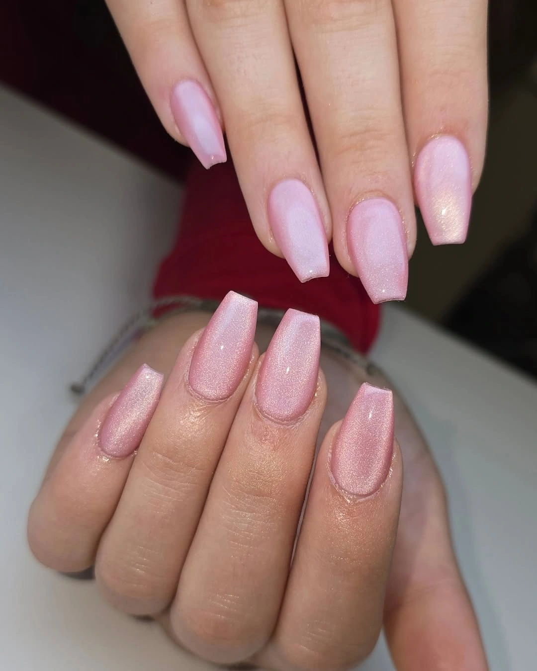 short pale pink coffin nails with a subtle pearly shimmer