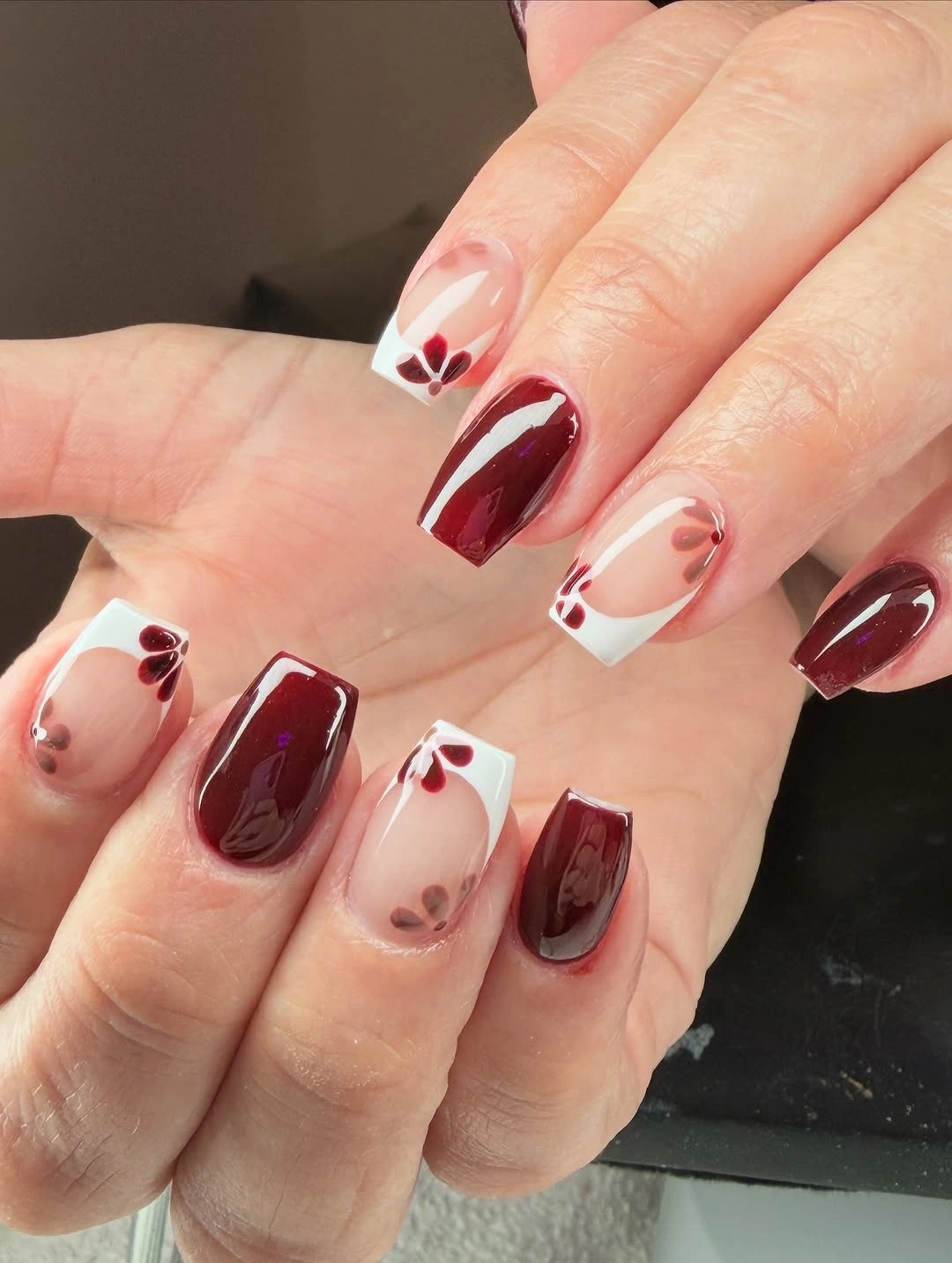 short nude coffin nails with burgundy blocks and pale lines