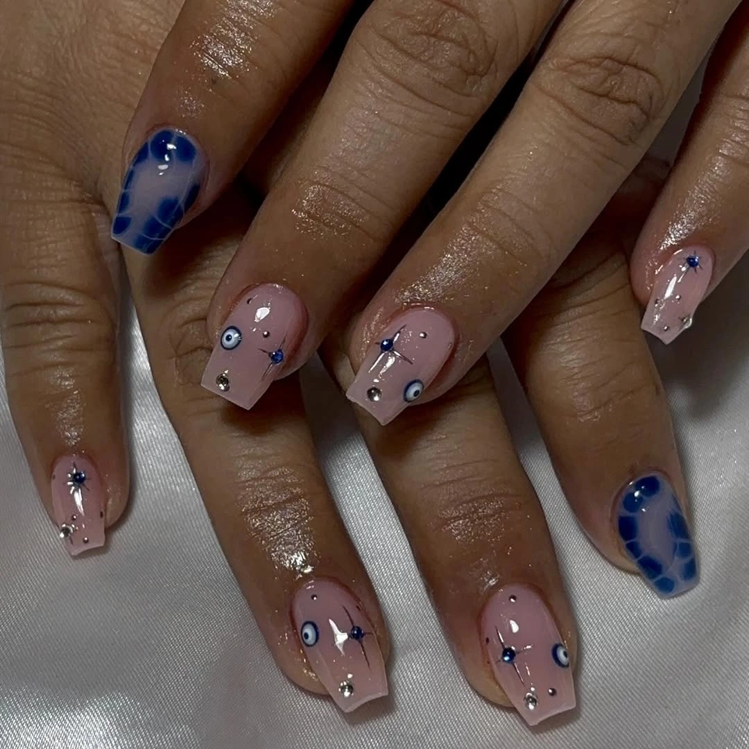 short nude coffin nails with navy accents and tiny star details