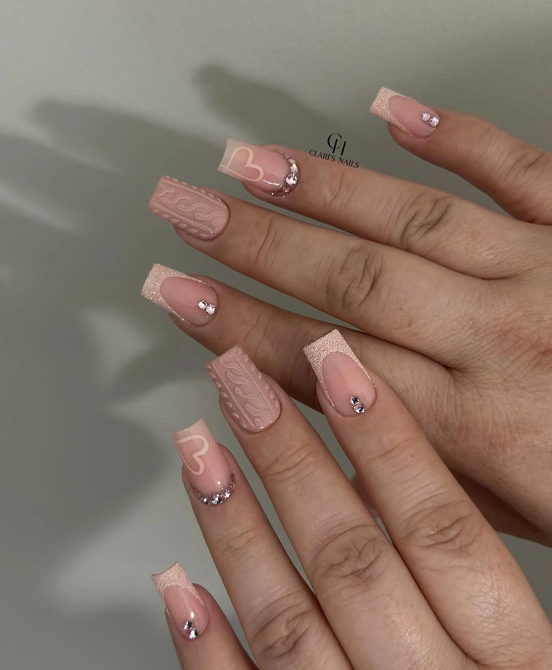short blush pink coffin nails with pale textured lines and sparkle