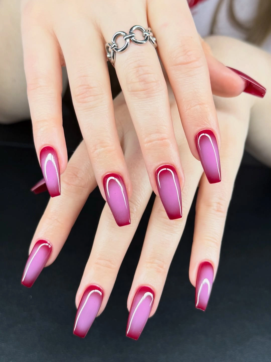 long magenta coffin nails with layered pale curved bands