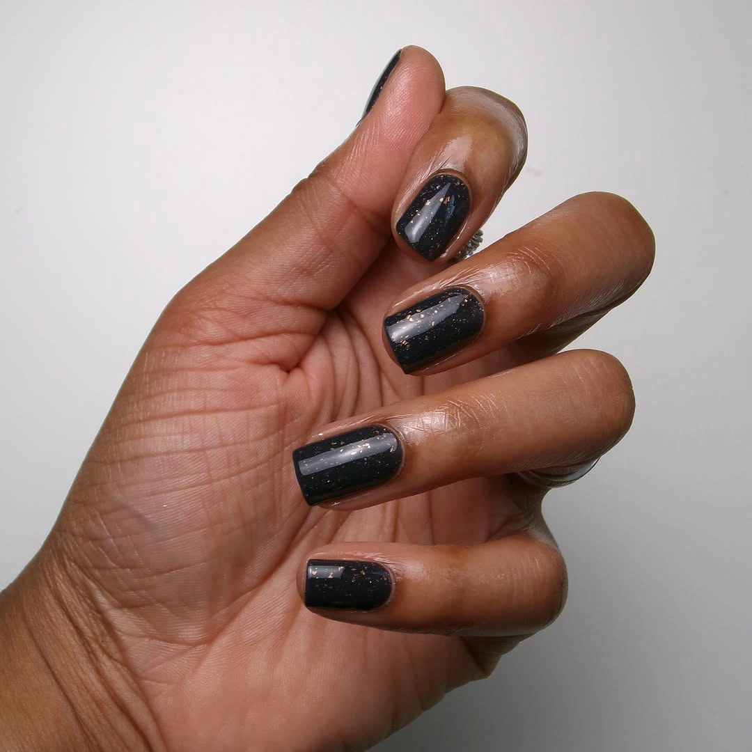 Glossy black square nails with subtle warm flecks