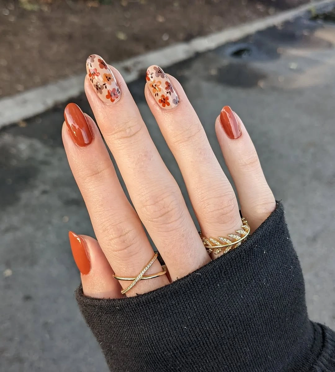 Burnt orange short nails with floral accent centers