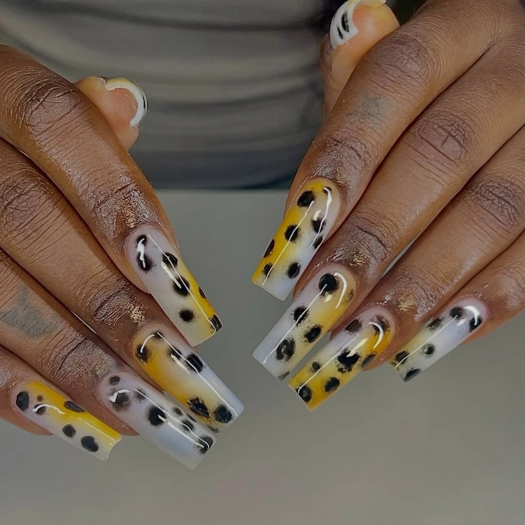 Long clear square nails with yellow black and white animal-print details