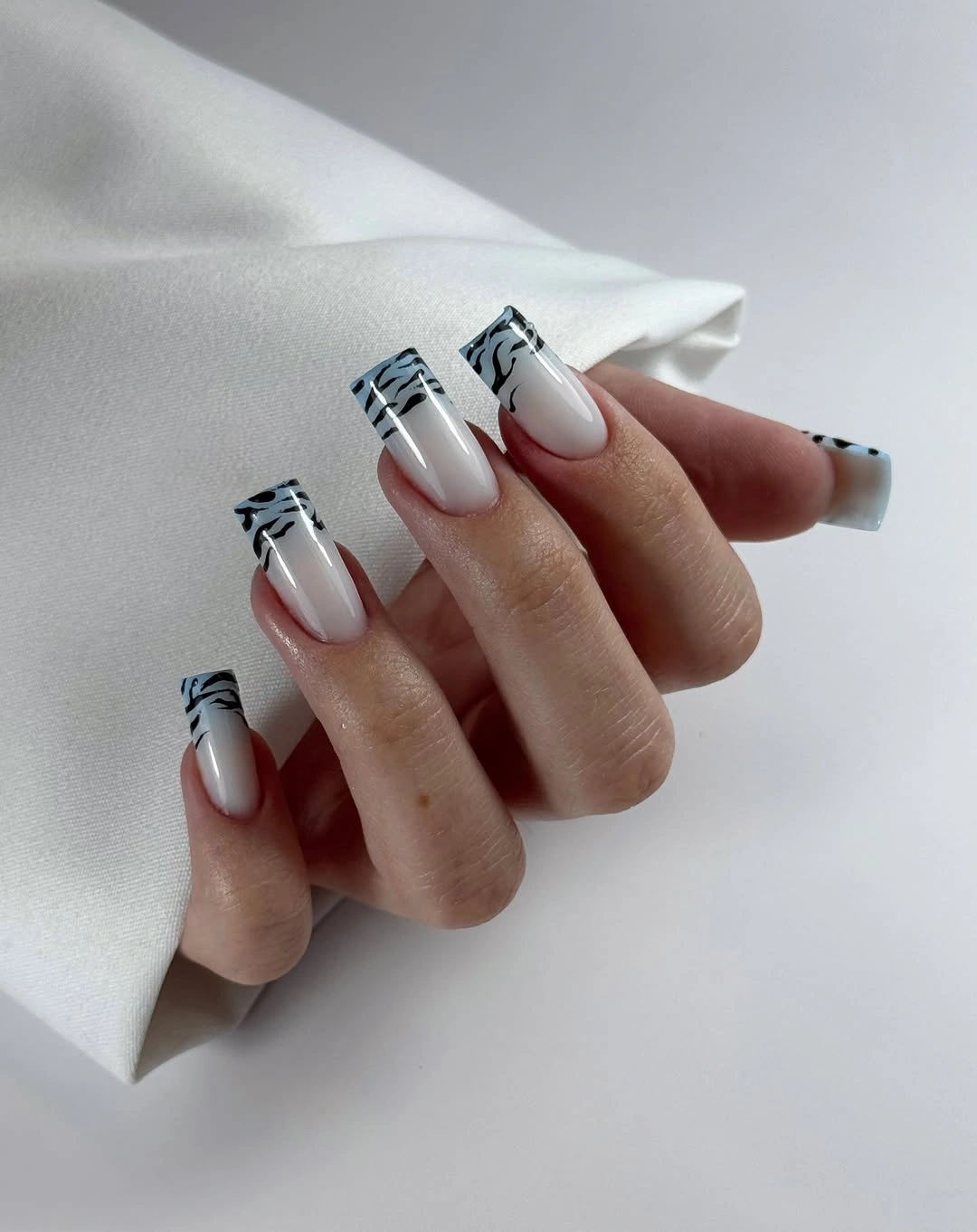 White square nails with thin black graphic French stripes