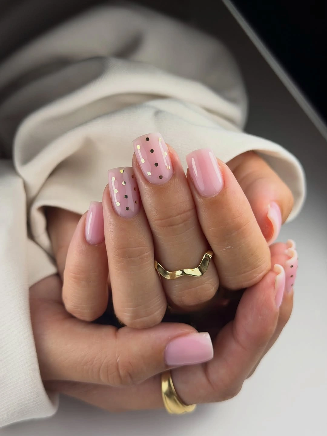Short pale pink square nails with tiny black dot accents