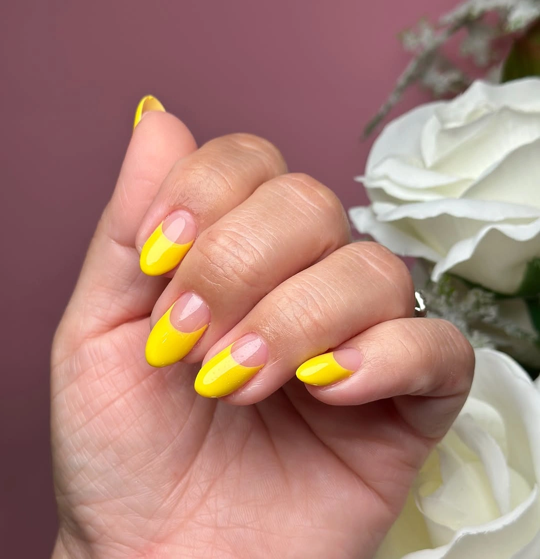 Medium almond nails with bright orange solids and leopard accents